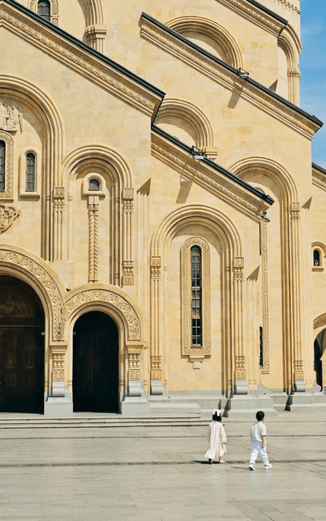 Ornate sandstone church facade with arched windows